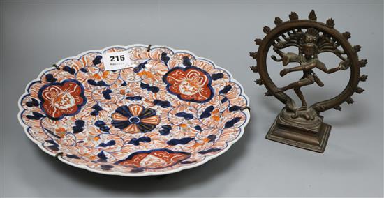 An Imari dish and a small bronze deity diameter 30.5cm